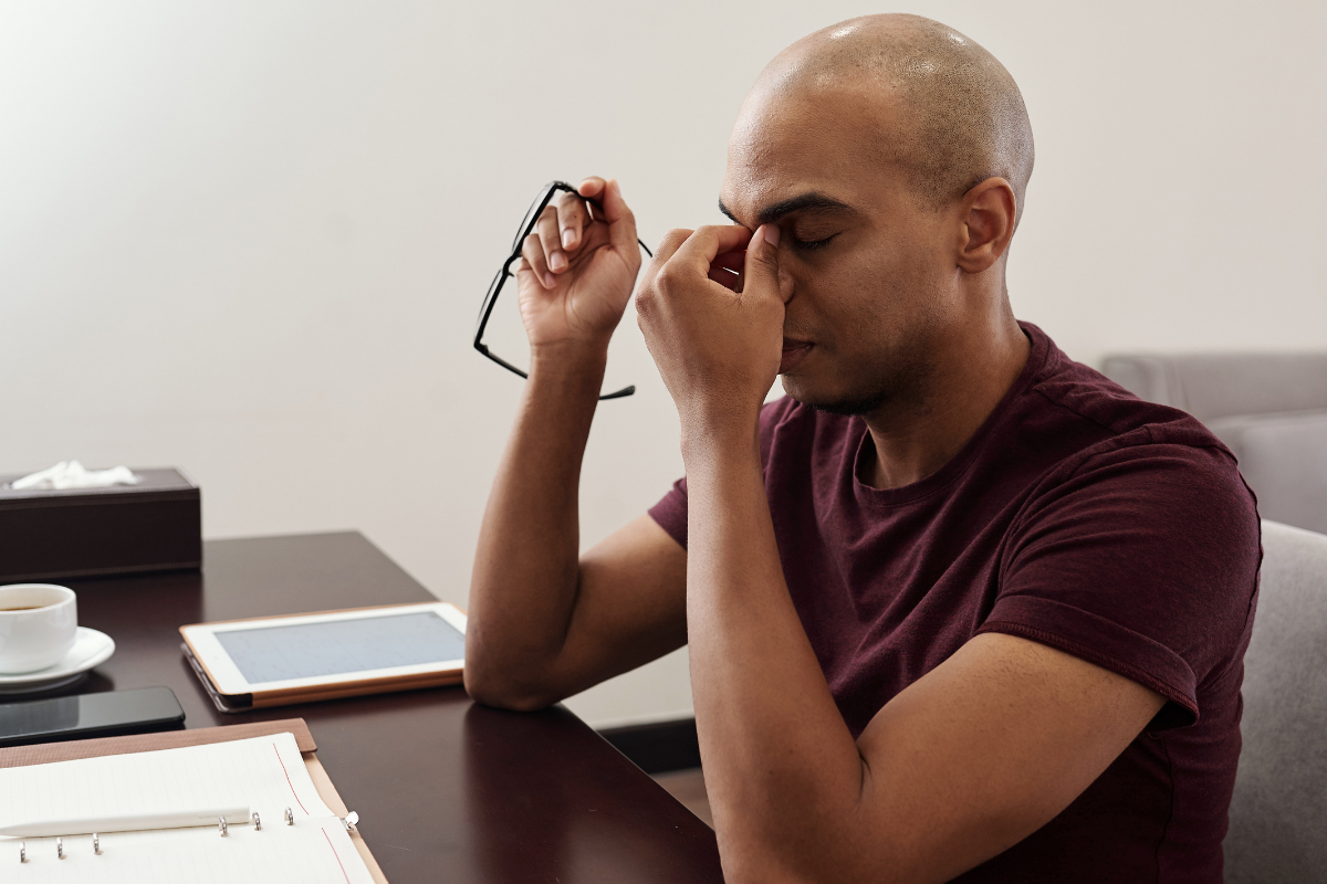 Man in the front of computer showing fatigue